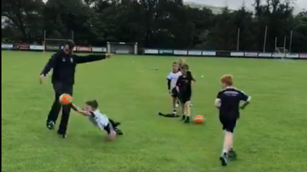 Conor Laverty coachings kids how to block down a gaelic football